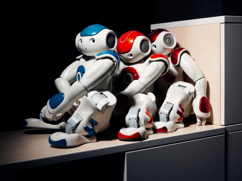 Deactivated robots leaning against each other on a shelf