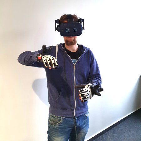 A human tutor demonstrating a pouring action using VR controllers